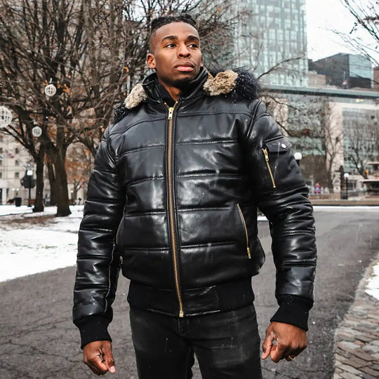 A model wearing the Ash hooded leather puffer jacket with a streetwear outfit, showcasing the urban aesthetic and mid-weight volume.