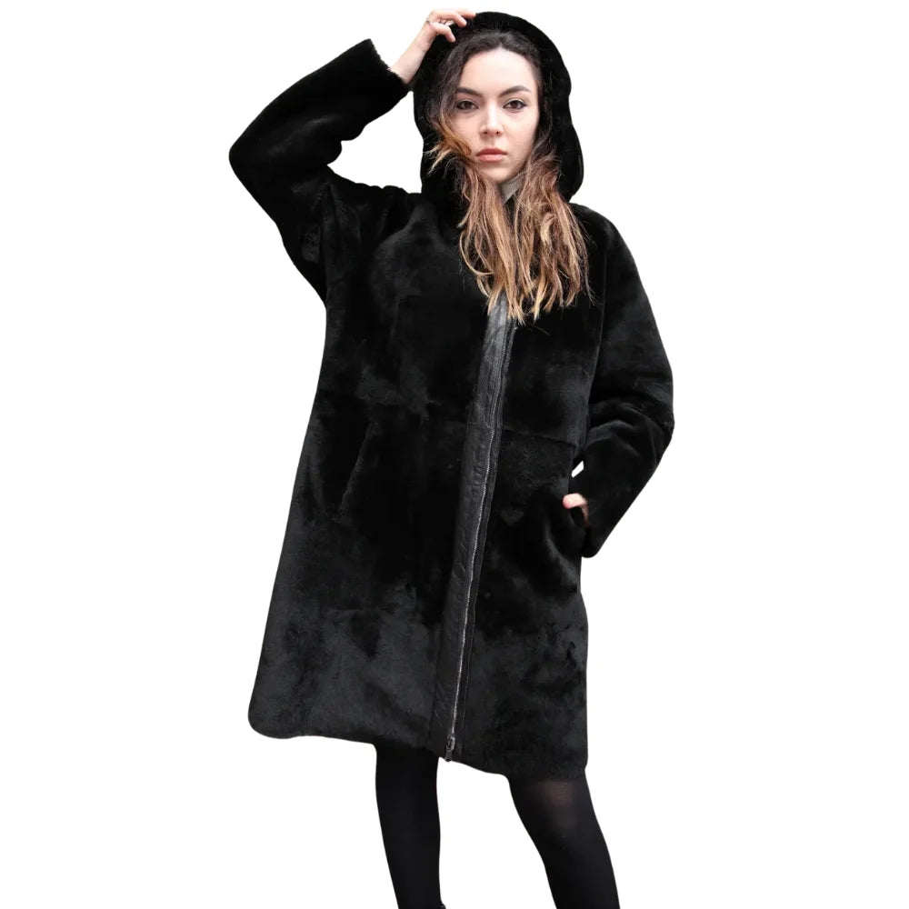 Close-up of model wearing the Avalon Black oversized reversible sheepskin long coat, styled for a fashionable and cozy winter look with its versatile and oversized design.