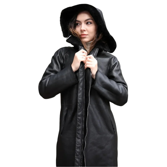 Model wearing the Avalon Black oversized reversible sheepskin long coat, styled for a fashionable and cozy winter look with its versatile and oversized design.