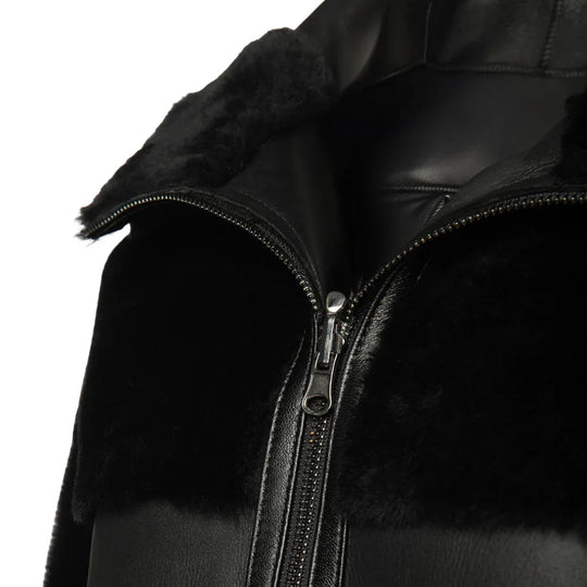 Close-up of the Elena jacket’s reversible texture, showing the contrast between the matte black leather and the thick, curly shearling lining.