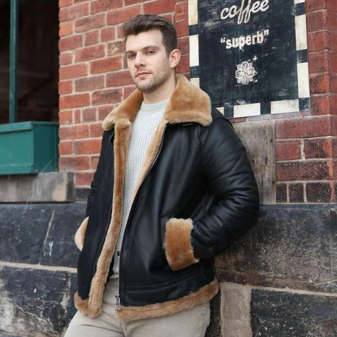 Man in a shearling jacket standing against a brick wall with a sign for Balzac's Coffee in the background.