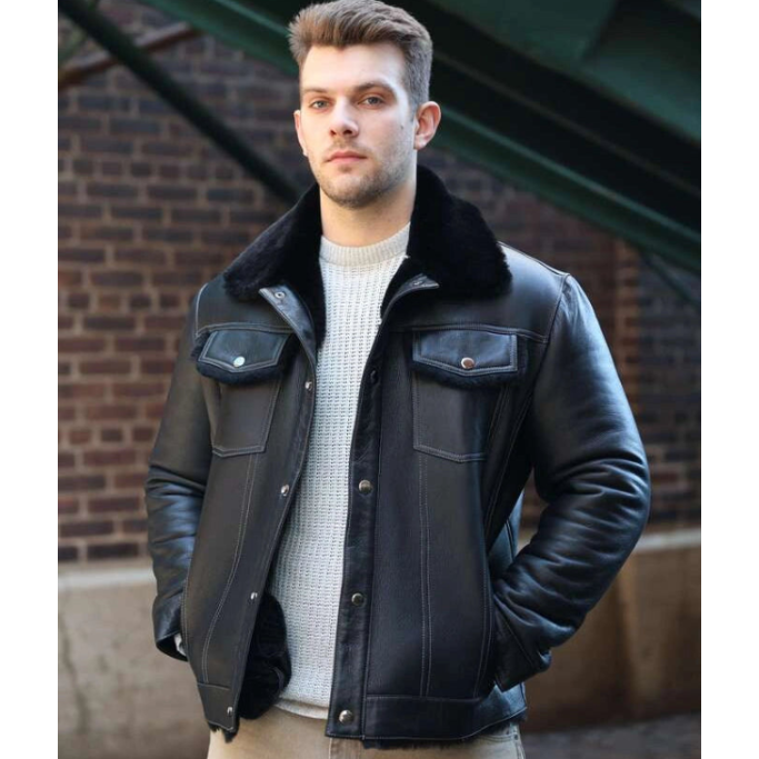 Man wearing a black leather jacket with a brick wall background