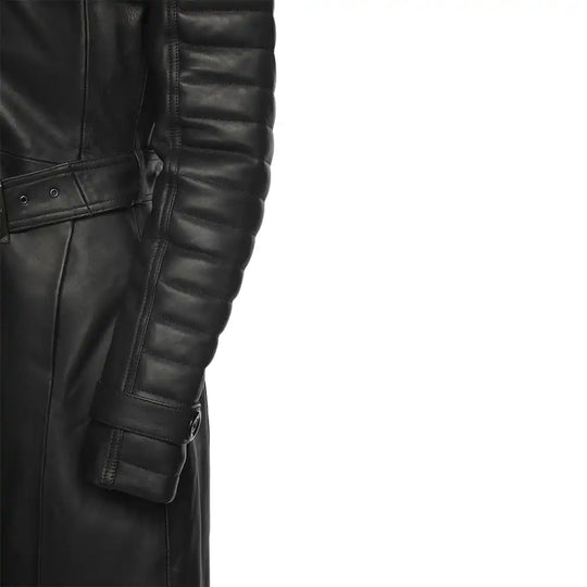 Close-up of a black leather trench coat with quilted sleeves on a white background