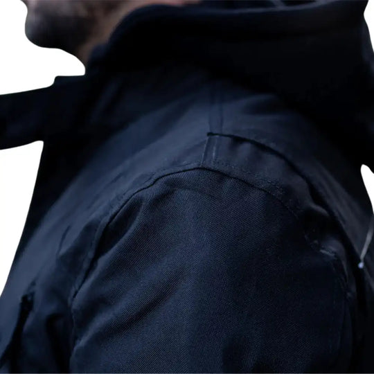 Close-up of an open chest vent showing the mesh lining and the toggle-adjustable airflow system.