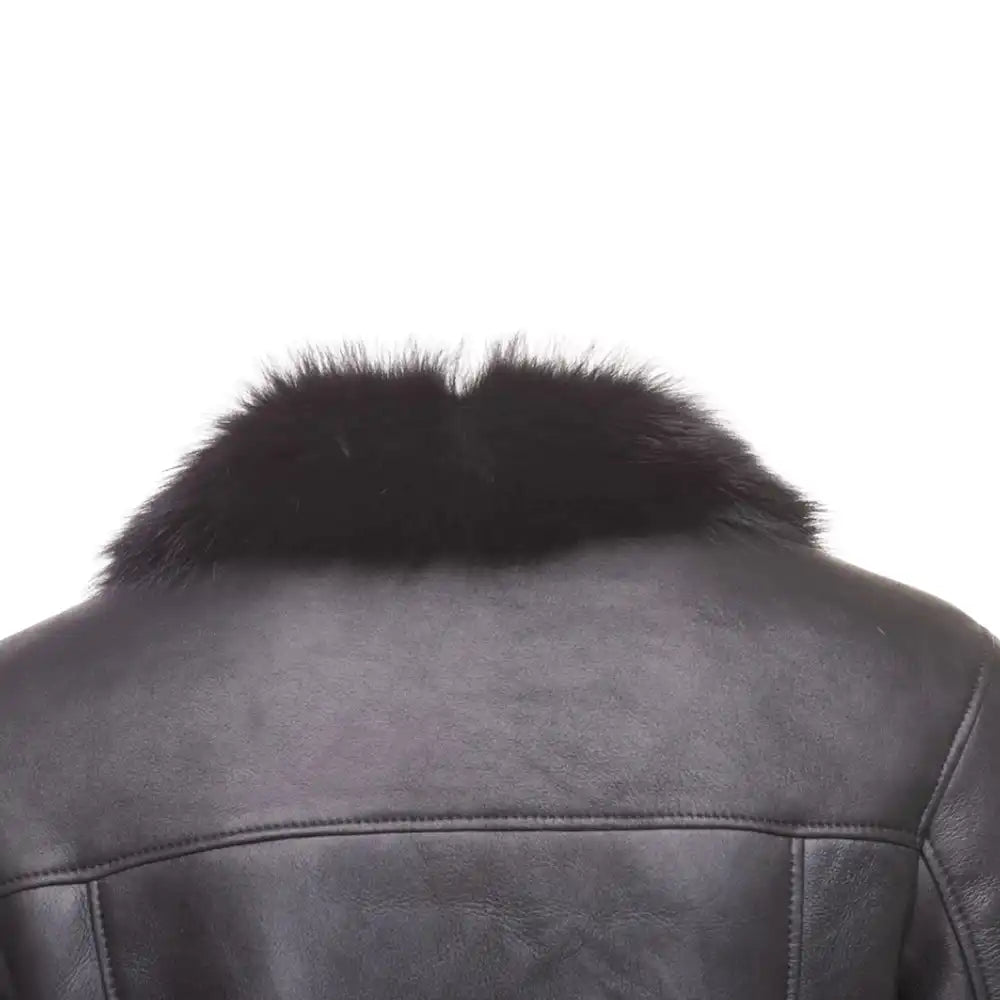 Rear Close-up of Black shearling trench coat with fur collar on a white background.