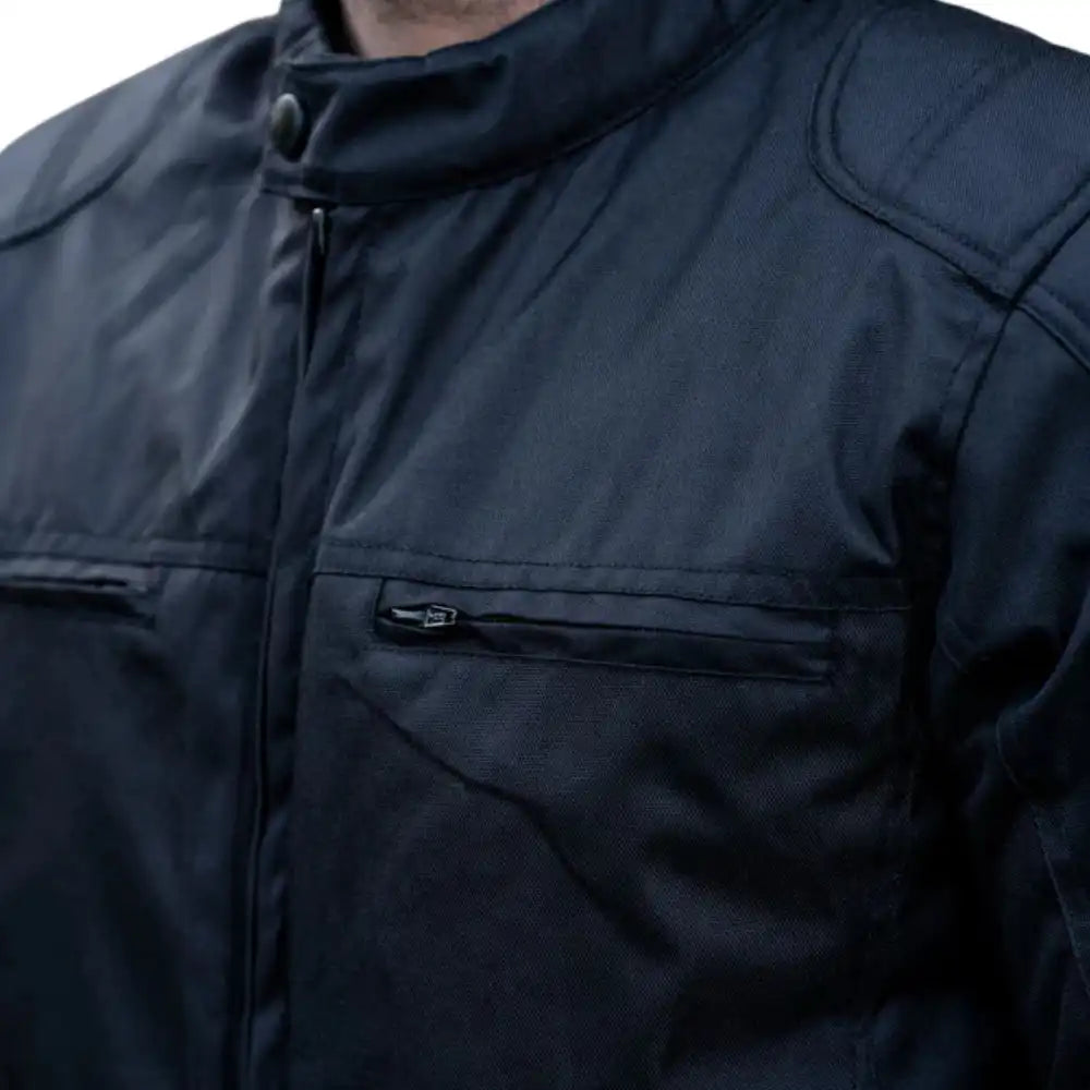 Close-up of the waterproof-treated leather grain and heat-sealed zippers designed to block moisture entry.