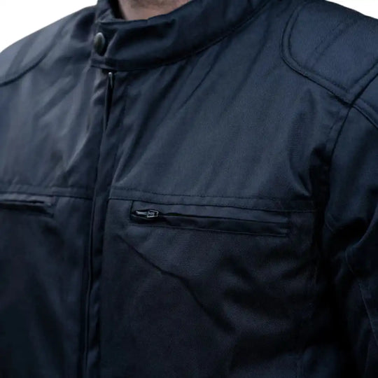 Close-up of the waterproof-treated leather grain and heat-sealed zippers designed to block moisture entry.