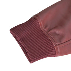 Detailed view of the ribbed knitted cuffs and hem of Justin's Burgundy A2 Bomber leather jacket, showing the jacket’s stylish and comfortable fit.