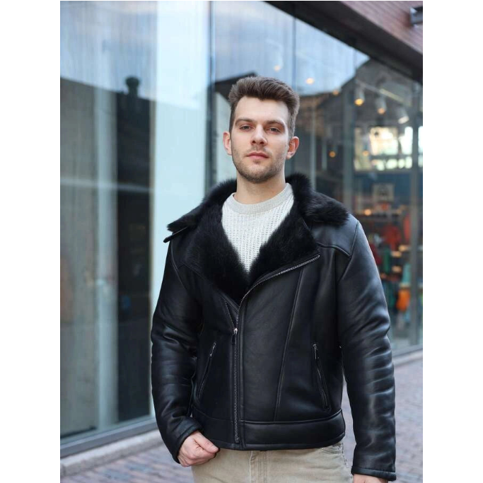 Man wearing a Carter's Toscana Shearling Leather Biker Jacket with fur collar standing in front of a glass building.