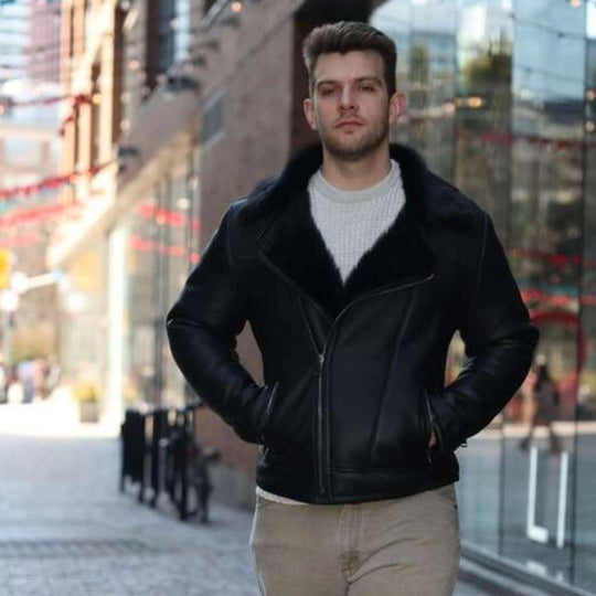Man wearing a Carter's Toscana Shearling Leather Biker Jacket and beige pants walking on a city street.