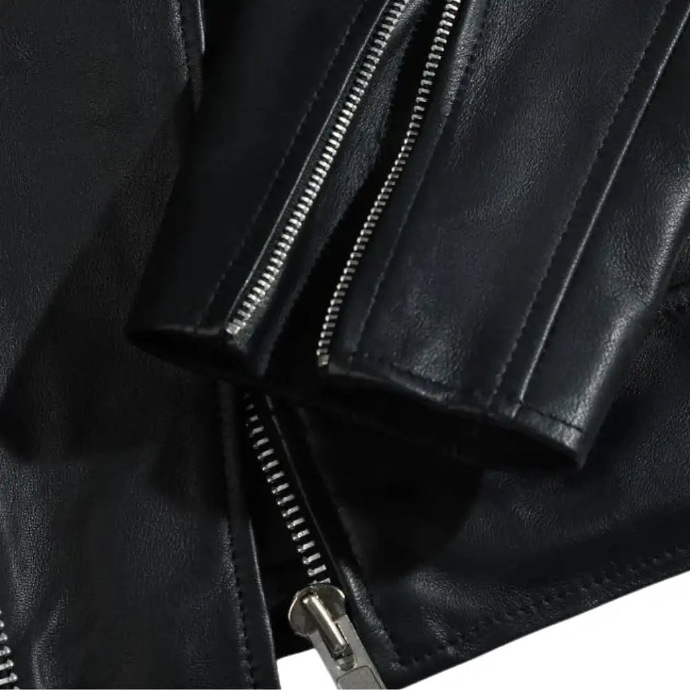 Close-up of the epaulette shoulder straps on the classic leather biker jacket, adding a bold military-inspired touch.