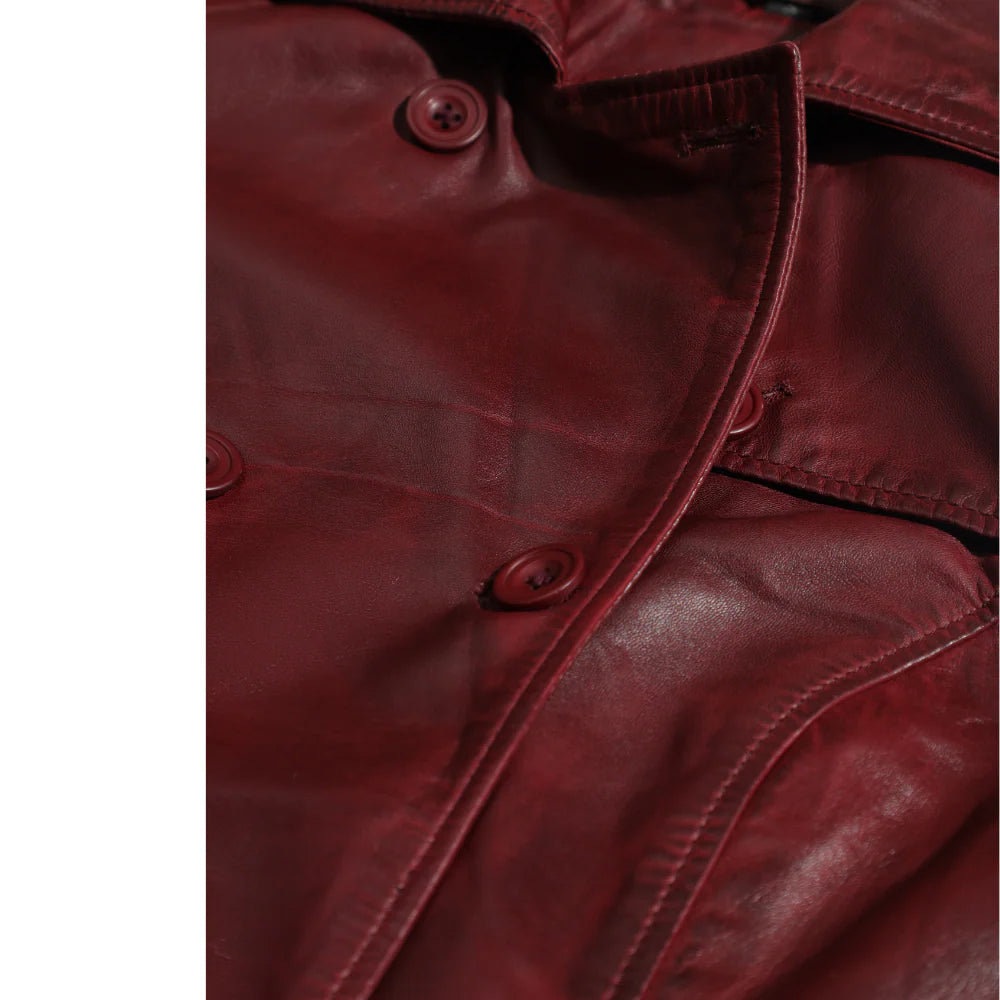 Close-up of a red leather jacket with buttons on a white background