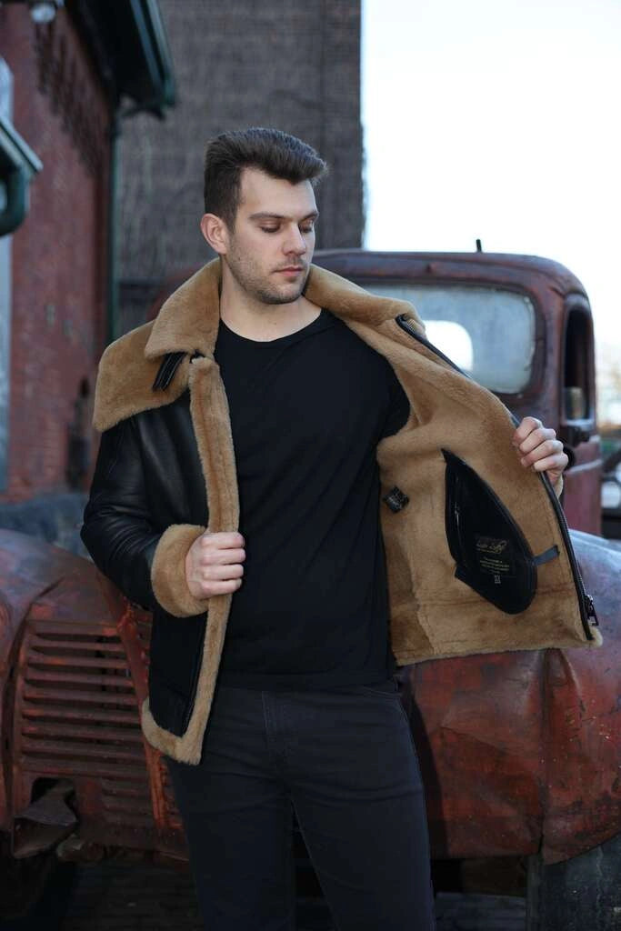 Man wearing Graysen black Aviator bomber shearling jacket in front of an old truck
