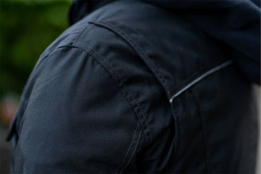 Close-up of the air-ventilation system, highlighting the zippered mesh intakes on the chest and perforated leather panels.