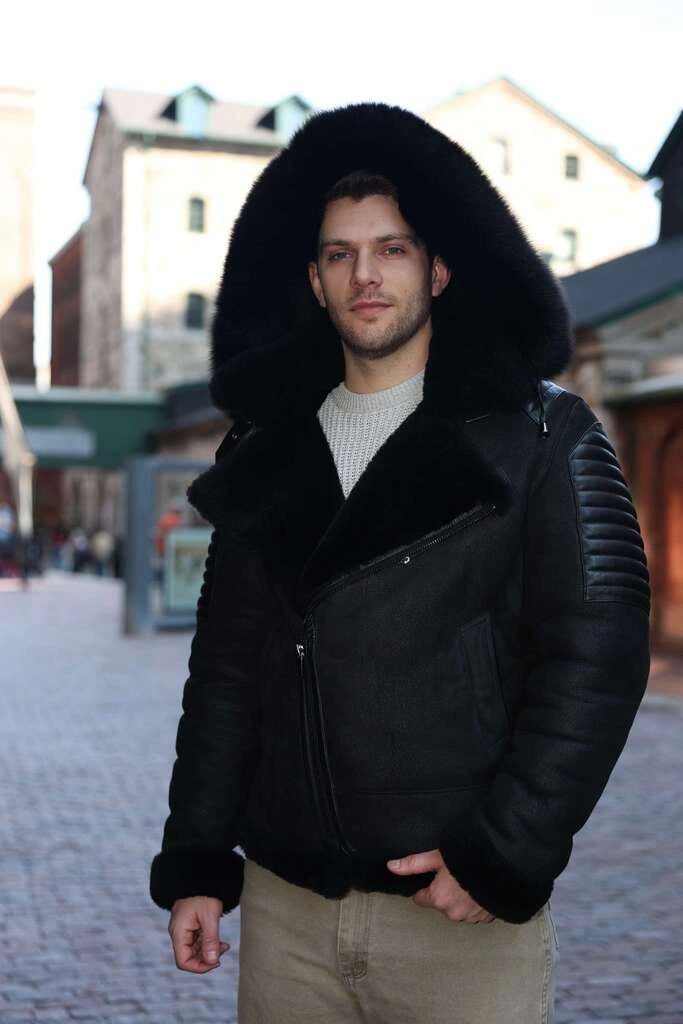 Man wearing Lucas Black Aviator Bomber Shearling Jacket with fur hood in an urban setting
