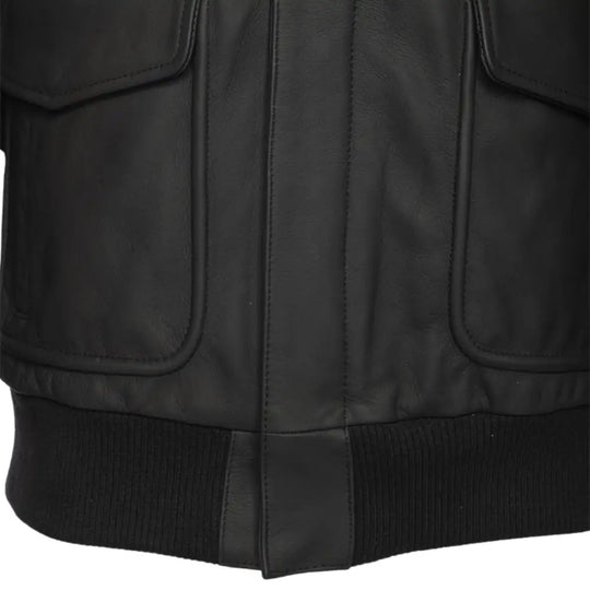 Close-up showing the zipper and grain texture of the matte black leather A2 bomber jacket.