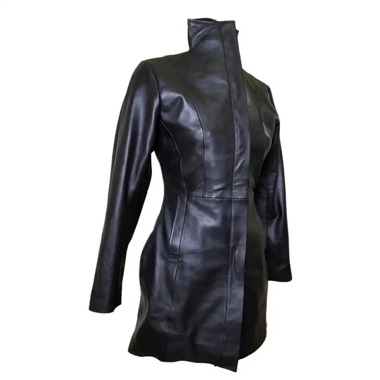Side profile view of Nelly's women's long leather coat on a mannequin, featuring double wind flaps and pockets and a button-down closure.