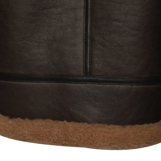 Close-up of the waist adjustment buckle on the Rob Brown B3 Bomber Jacket, designed for a customizable fit. The buckle is paired with tan shearling lining along the jacket’s waist.