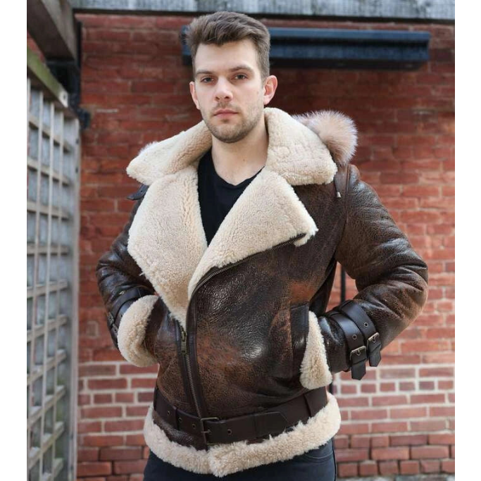 Man wearing Rocco vintage brown aviator shearling jacket with white fur lining against a brick wall.