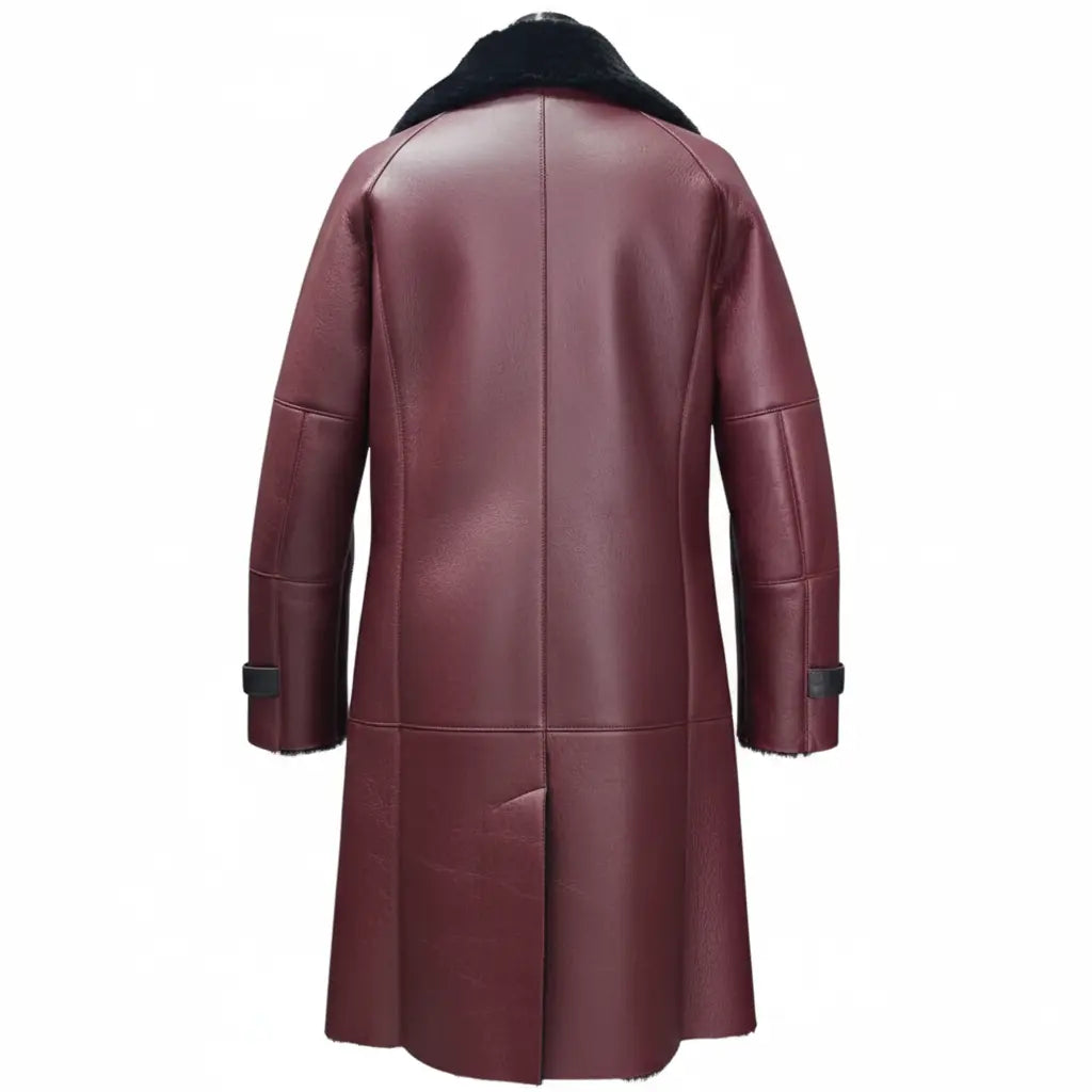 The back view of a women's burgundy leather shearling coat highlighting the structured panel stitching, longline cut, and the top of the black shearling collar on a white backgorund.