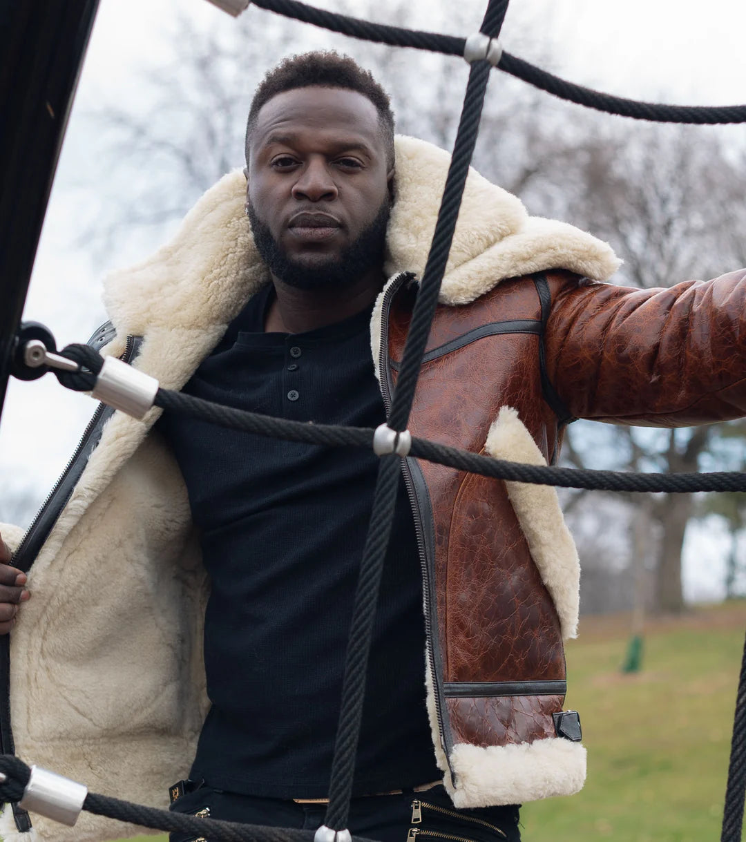 Man wearing a Terry Gretzky Vintage Oxblood bomber jacket with double collar in an outdoor setting.