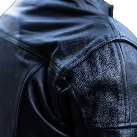 Close-up of the dual-density external shoulder and elbow sliders with "The Real Racer" branding on high-abrasion leather.