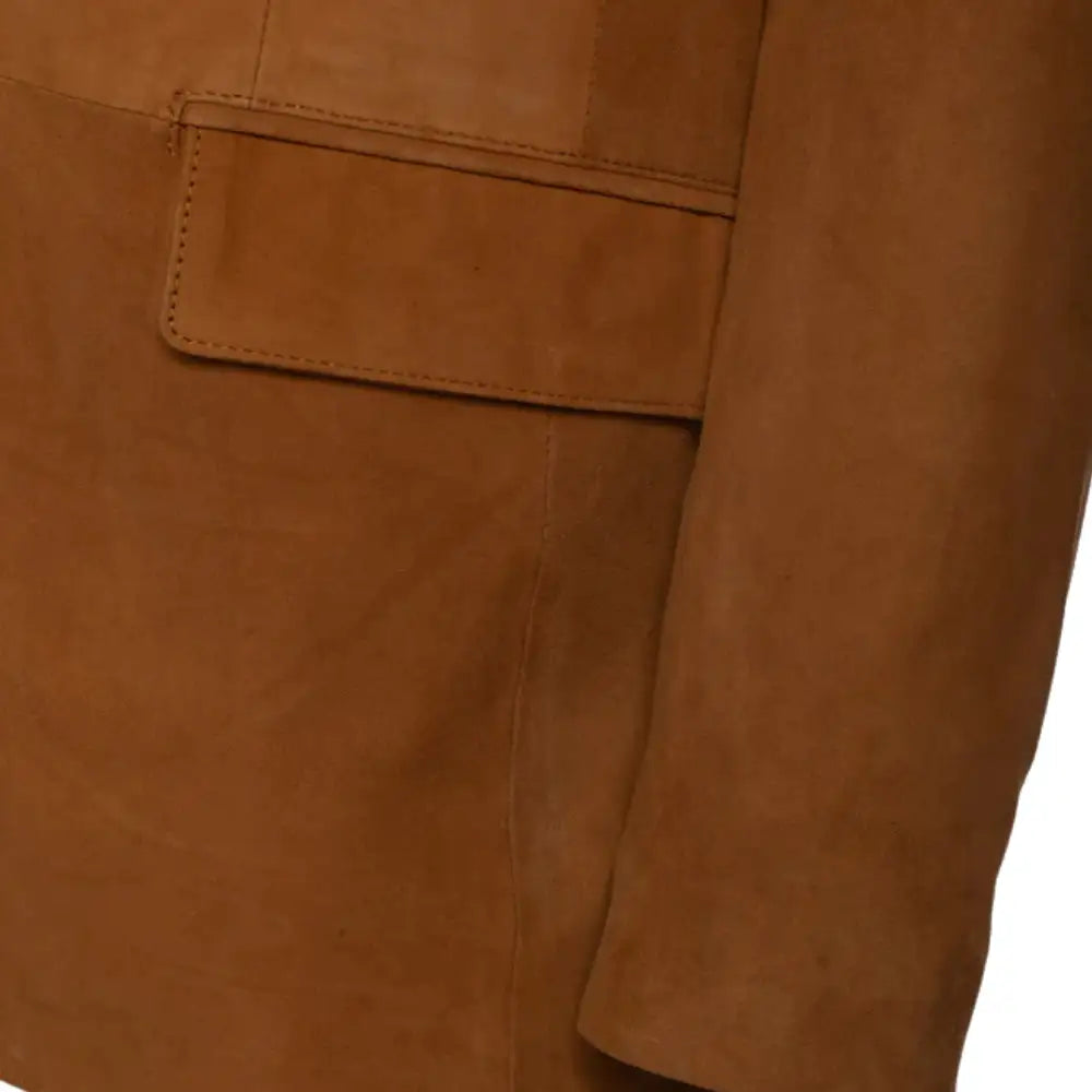 Close-up of a tan suede leather blazer with a pocket and sleeves detail on a white background